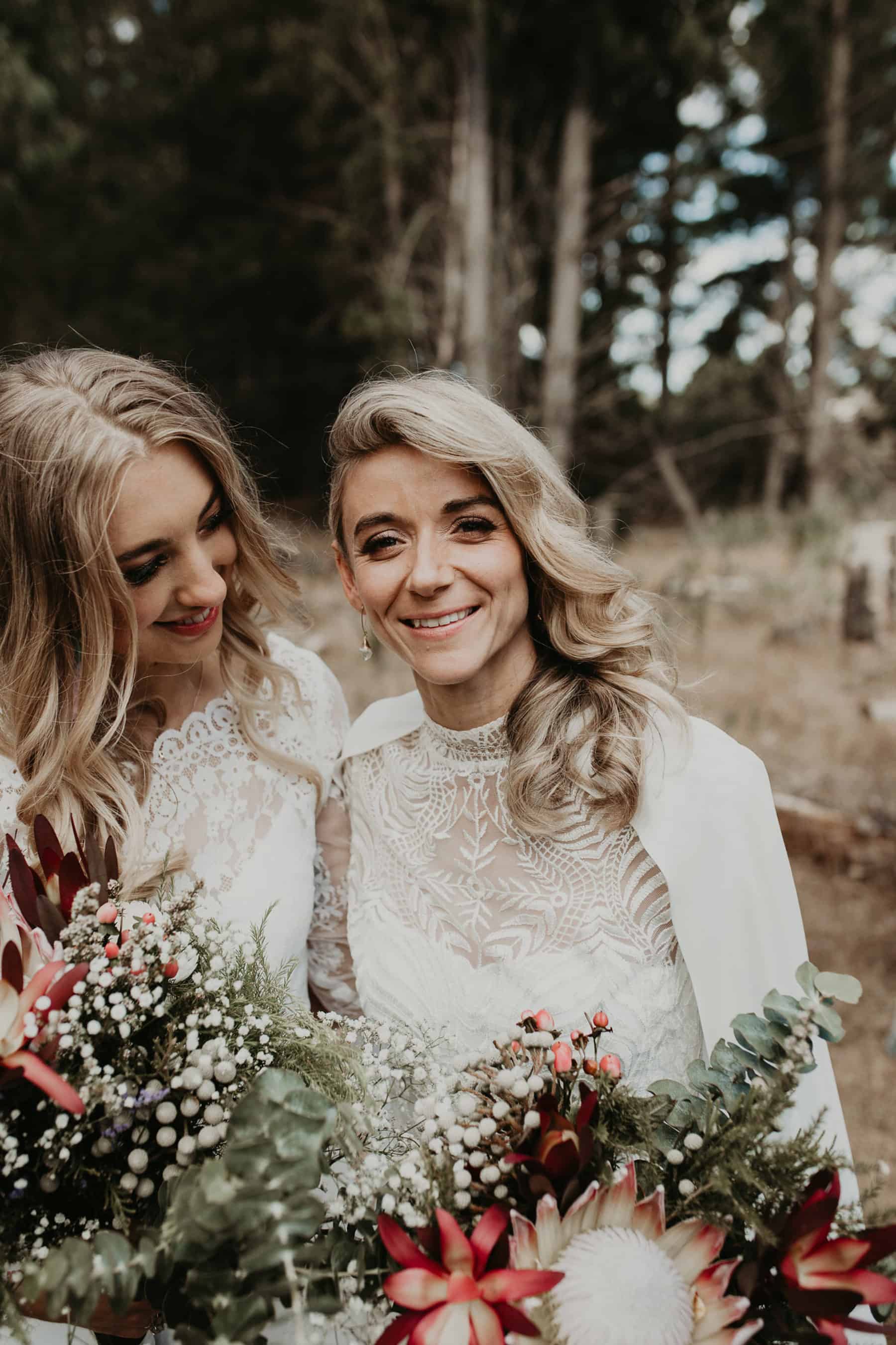 two boho brides with king protea bouquets