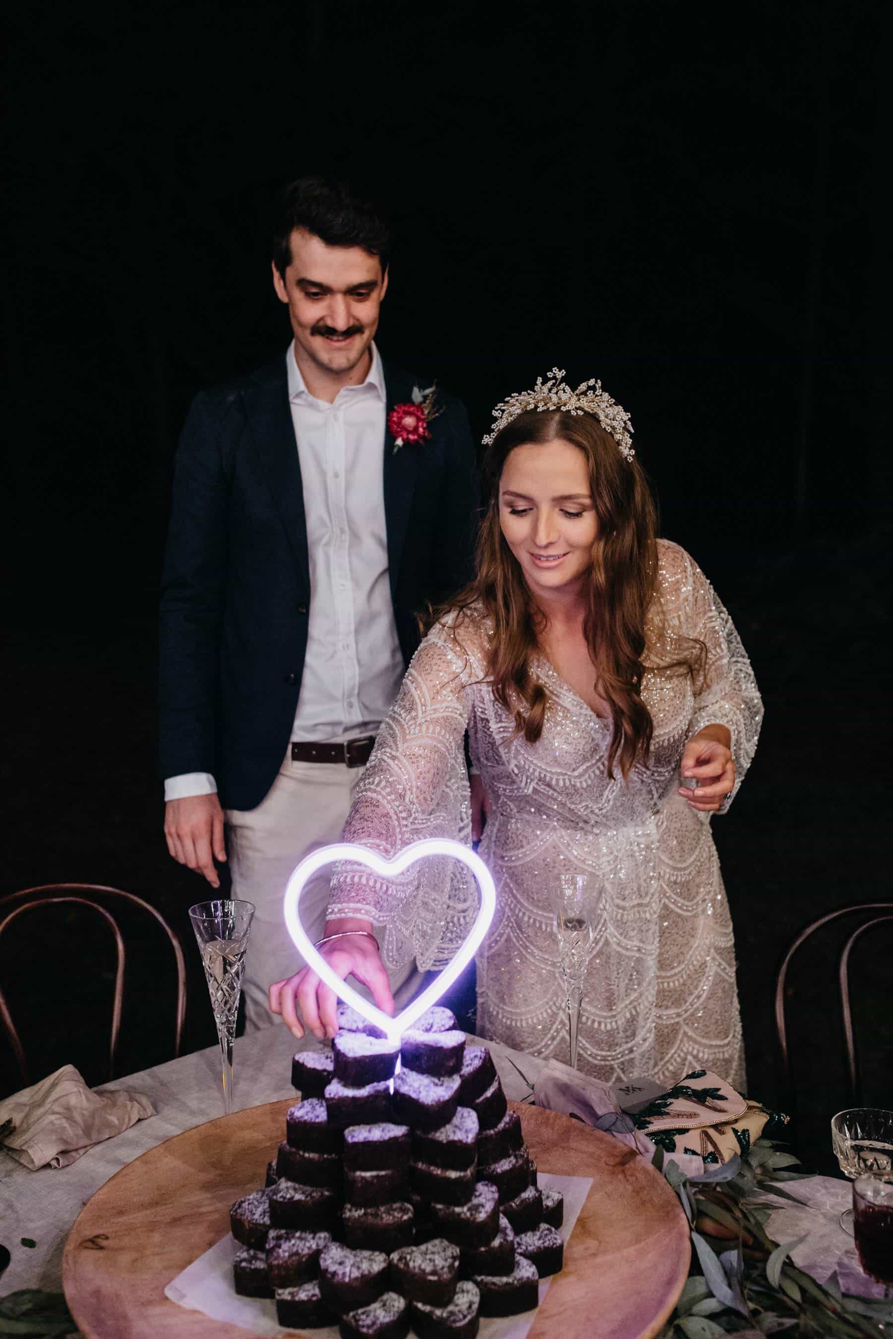 brownie wedding cake with neon heart topper