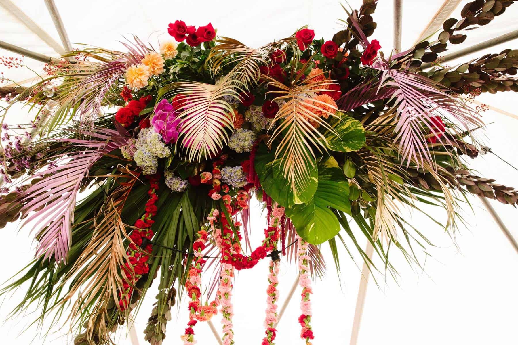 colourful floral installation with painted palm leaves