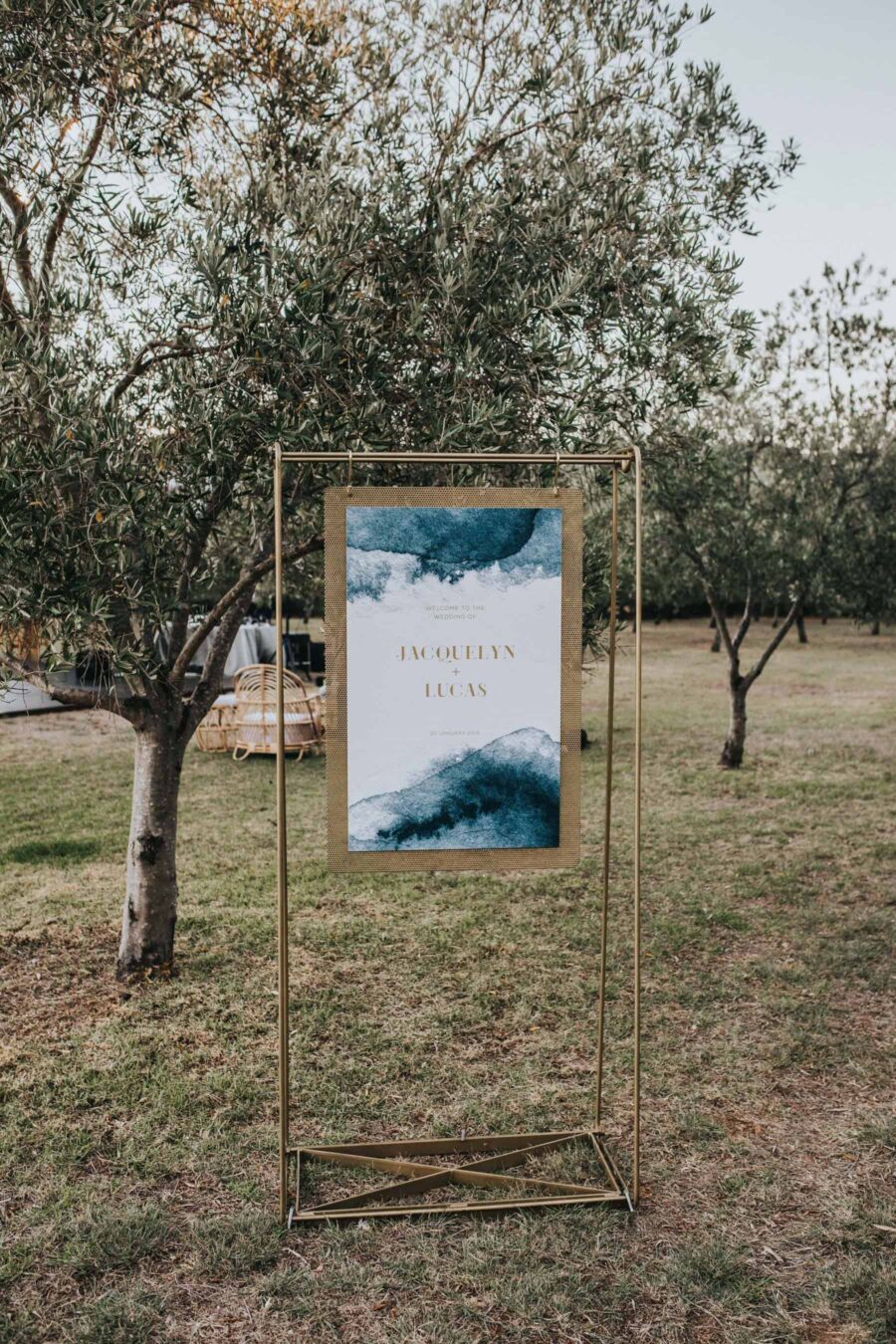 watercolour wedding signage in gold swing frame