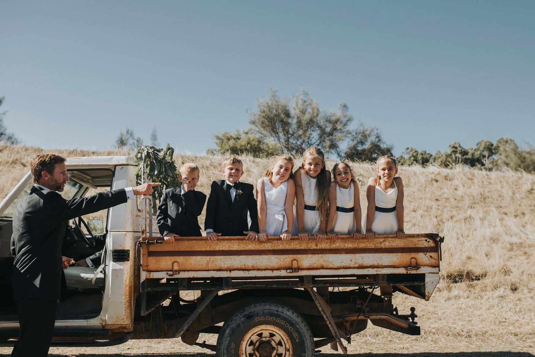 flower girls and page boys on an old ute - Australian wedding