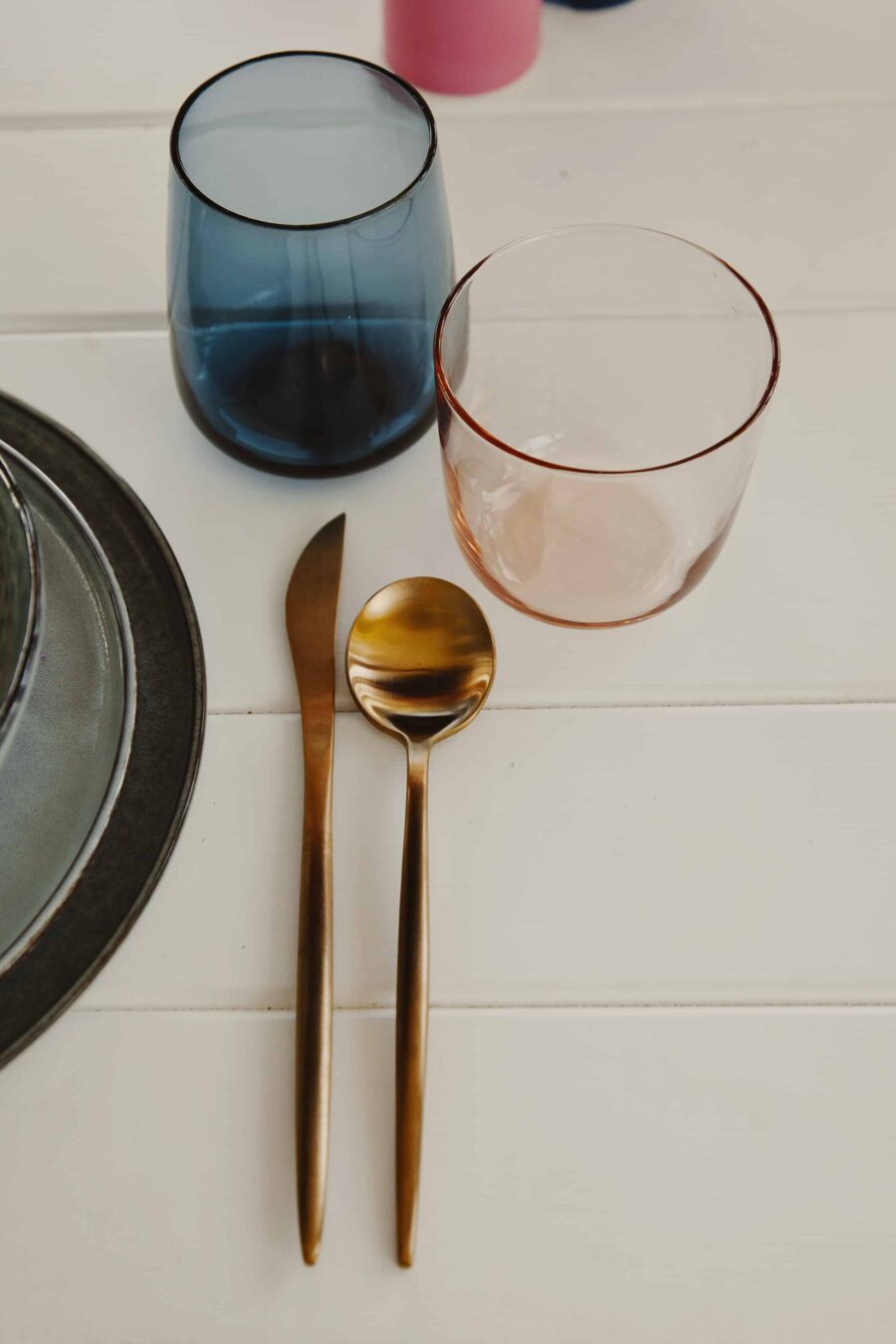 modern mid-century inspired tablescape with coloured glassware