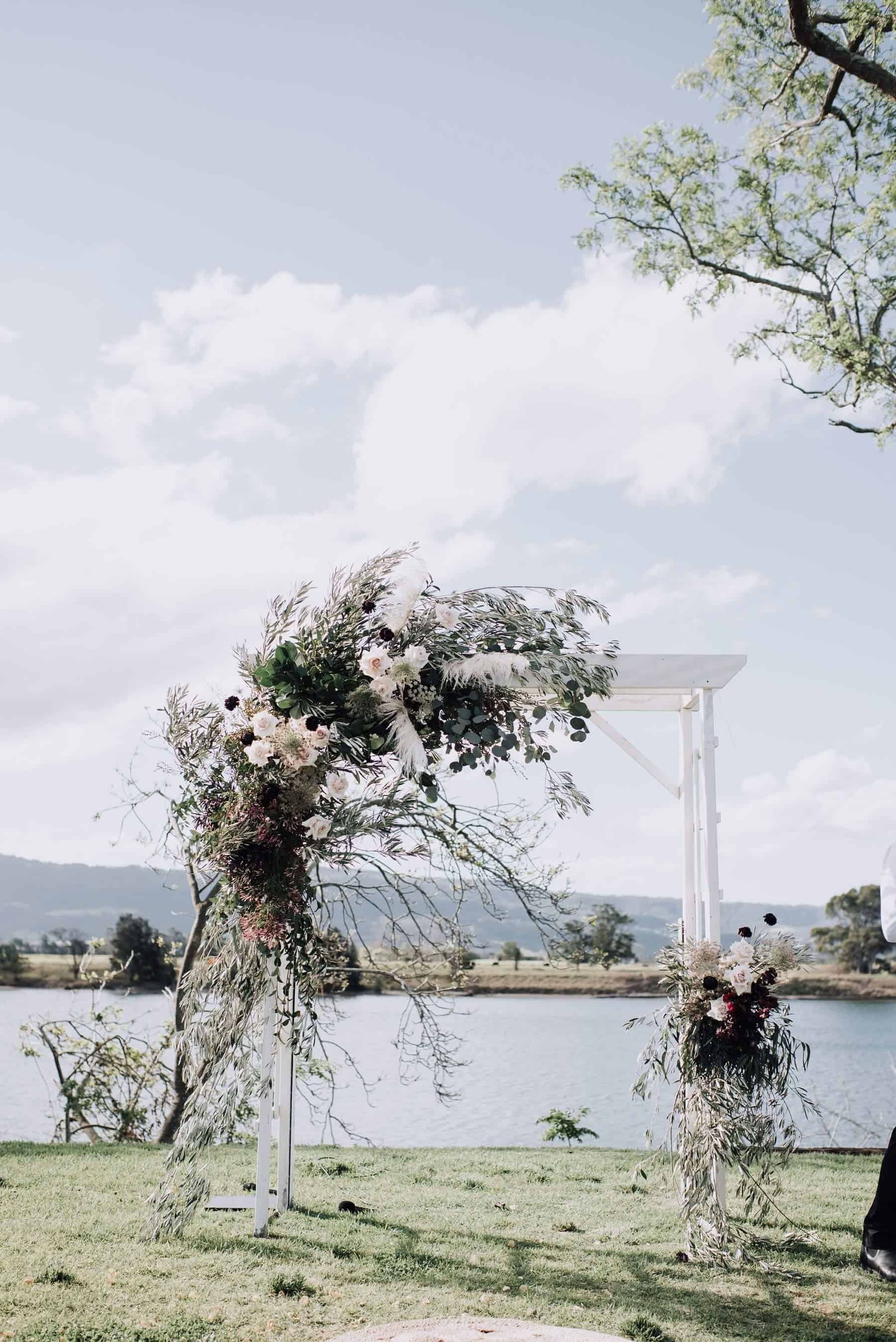 floral wedding arbour in blush and plum palette