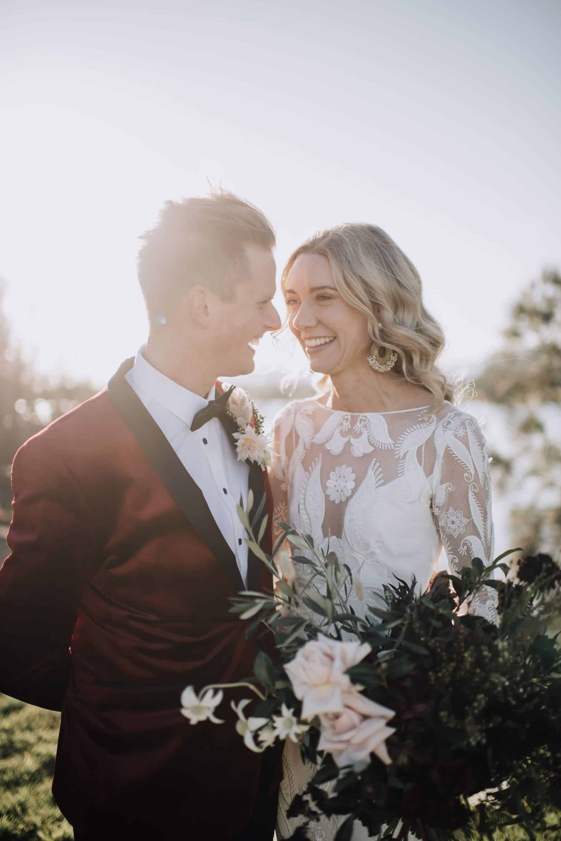 boho bride and groom in burgundy jacket