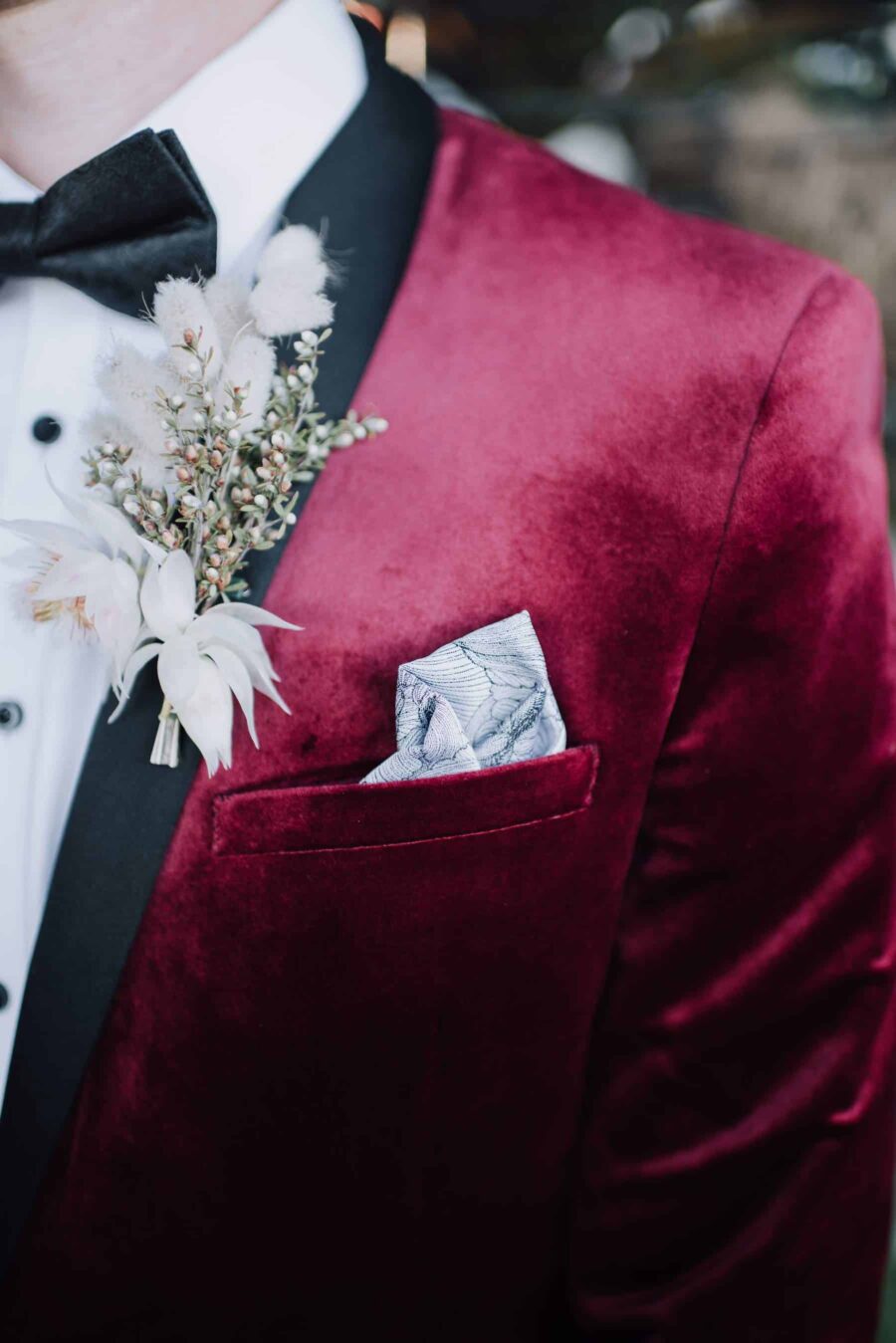 dapper groom in burgundy velvet jacket