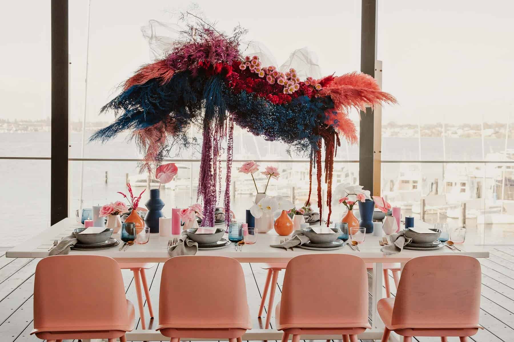 bright pink floral installation over tablescape
