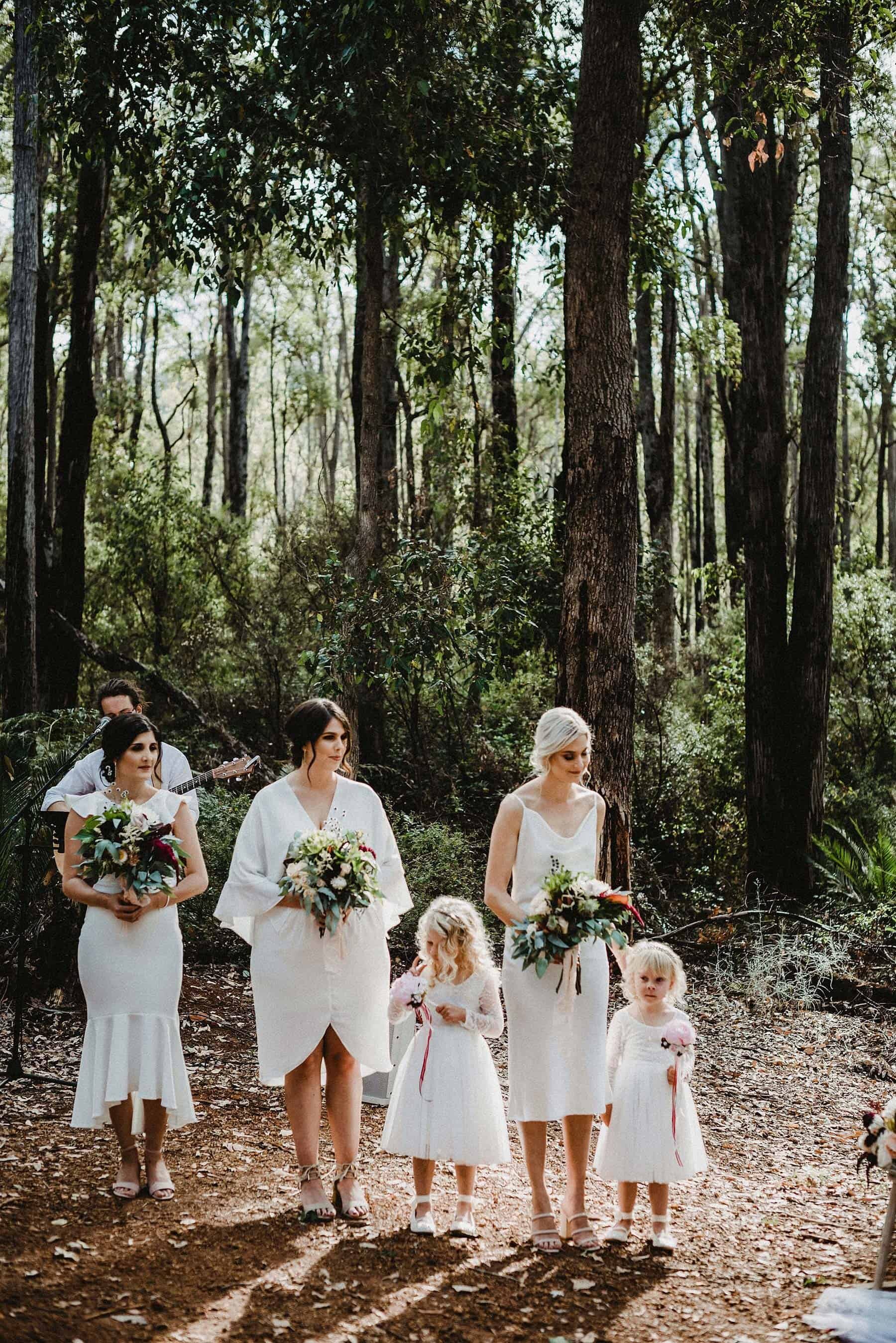 Bridesmaids and flower girls in rustic forest wedding