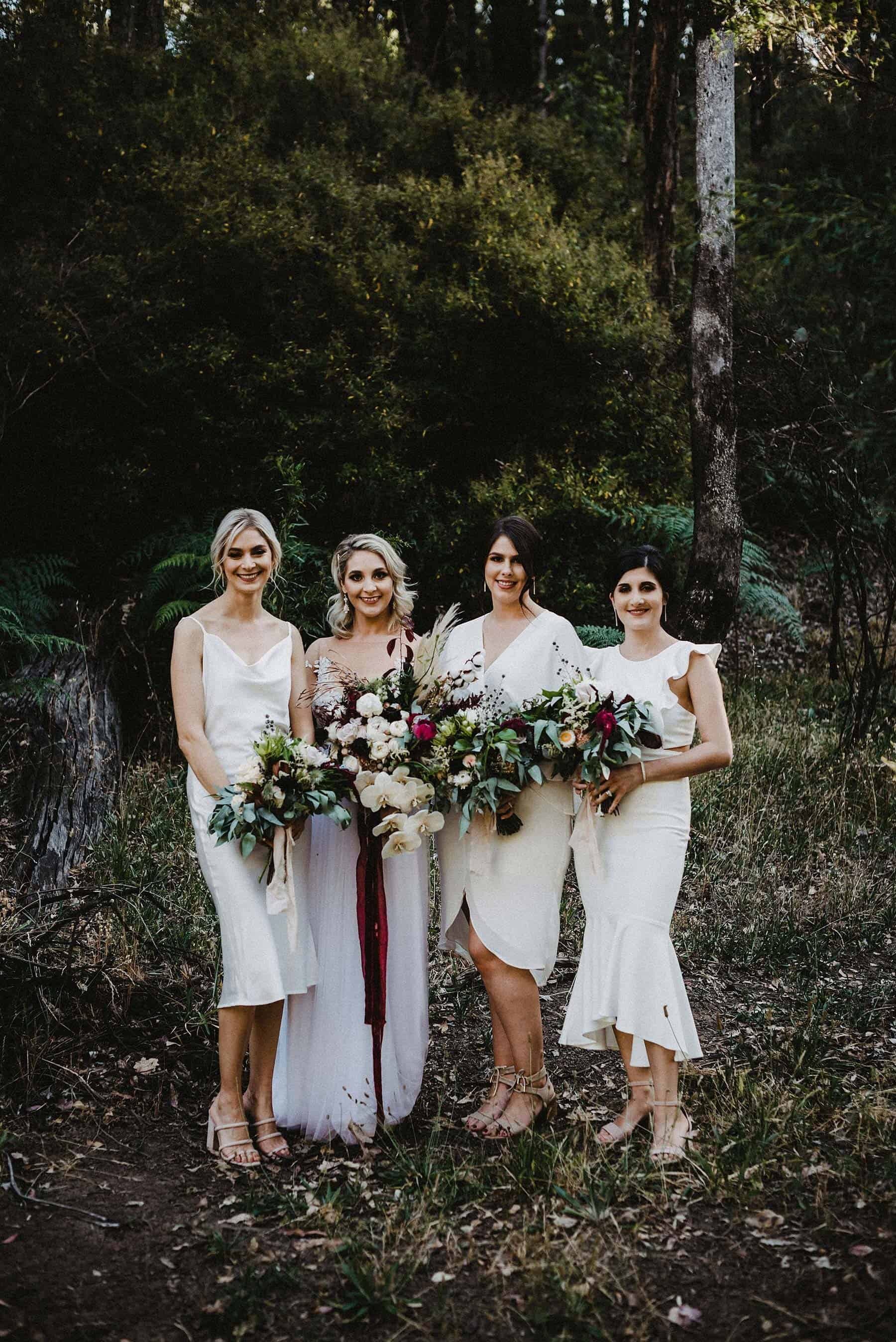 White bridesmaid dresses with native bouquets