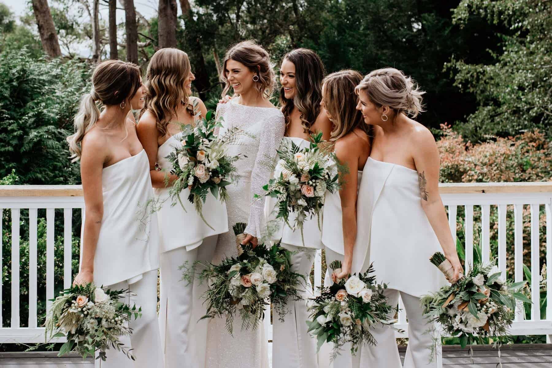 modern bride and bridesmaids in white jumpsuits
