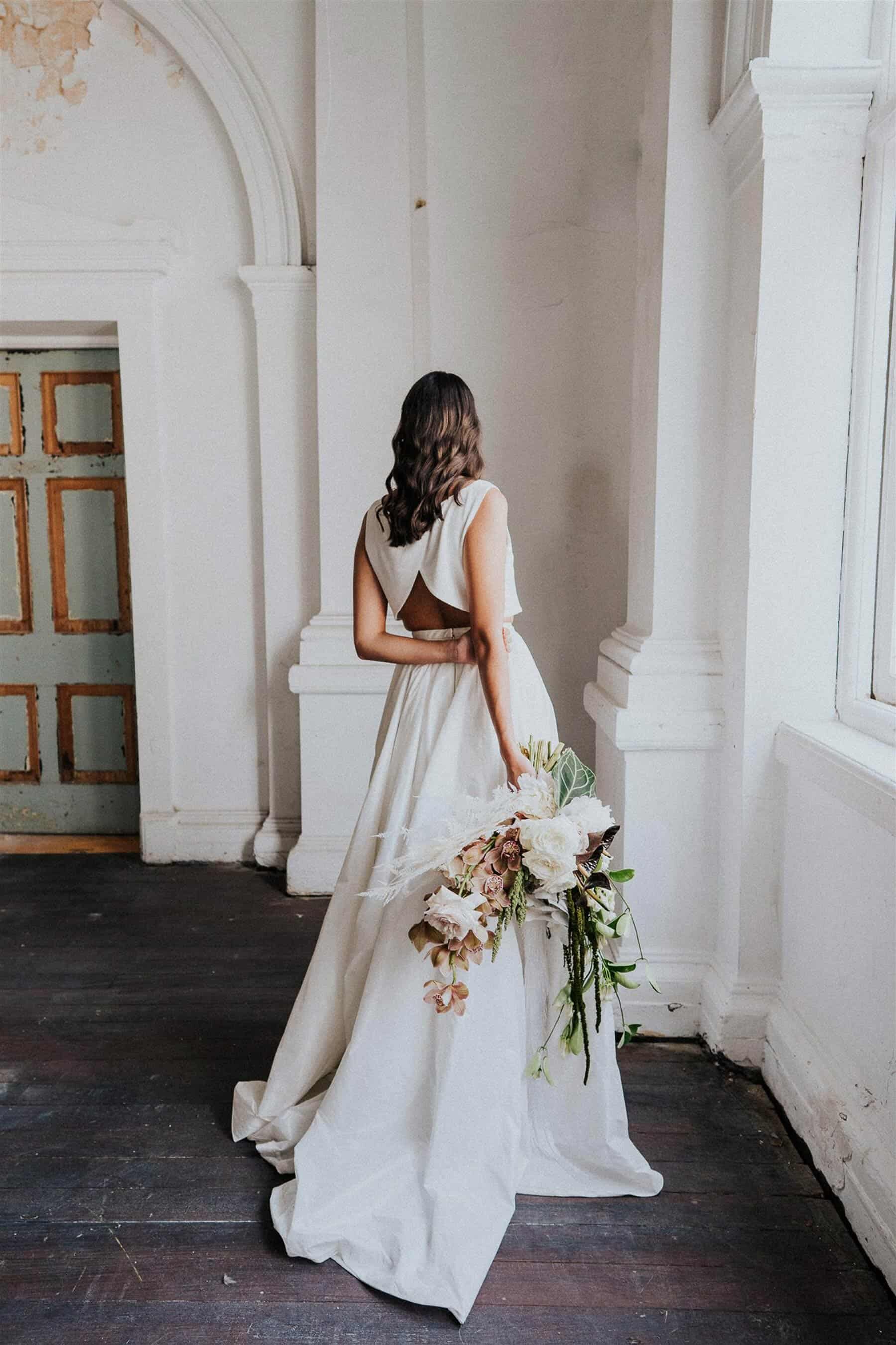 bride in modern skirt and crop-top wedding dress
