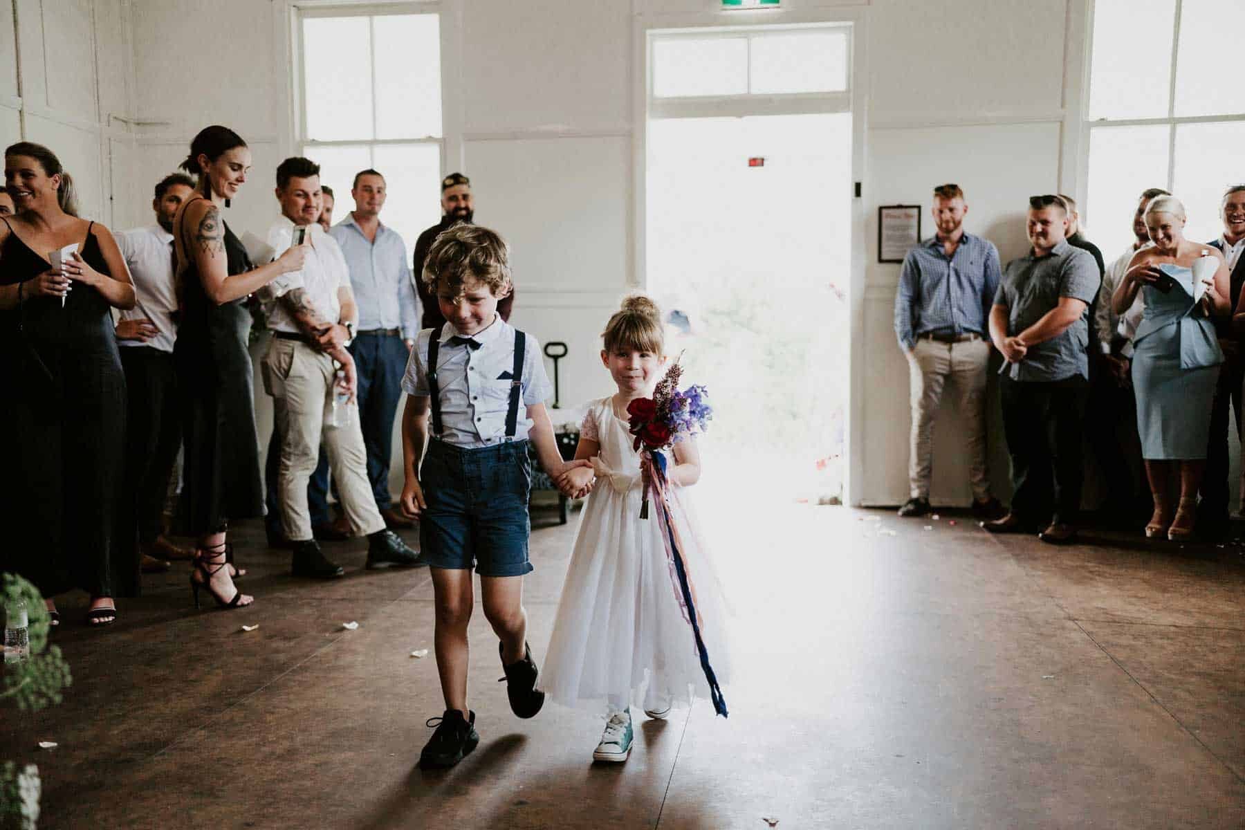 page boy and flower girl walking down the aisle