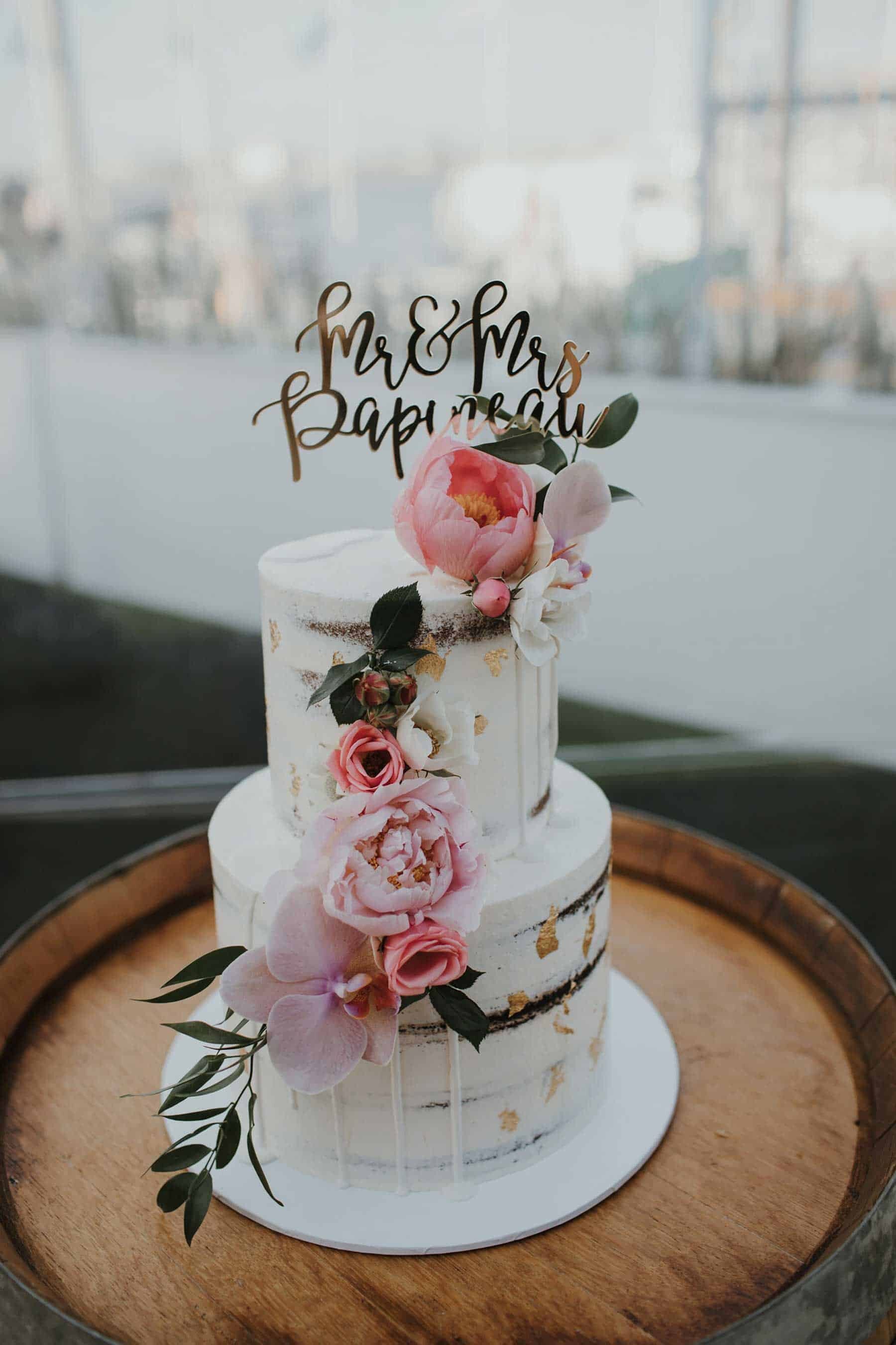 semi naked wedding cake with pink flowers