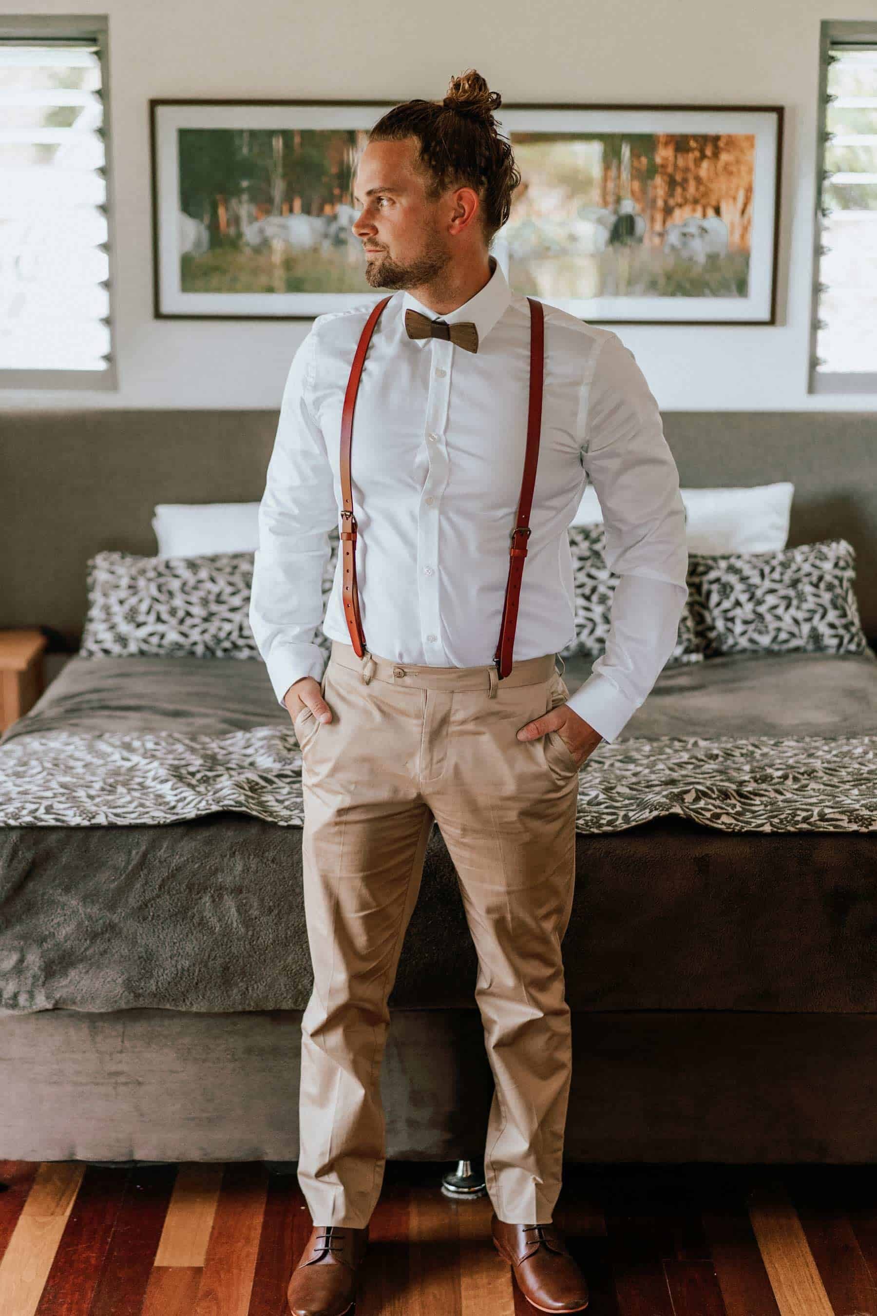 casual groom in braces and wooden bow tie