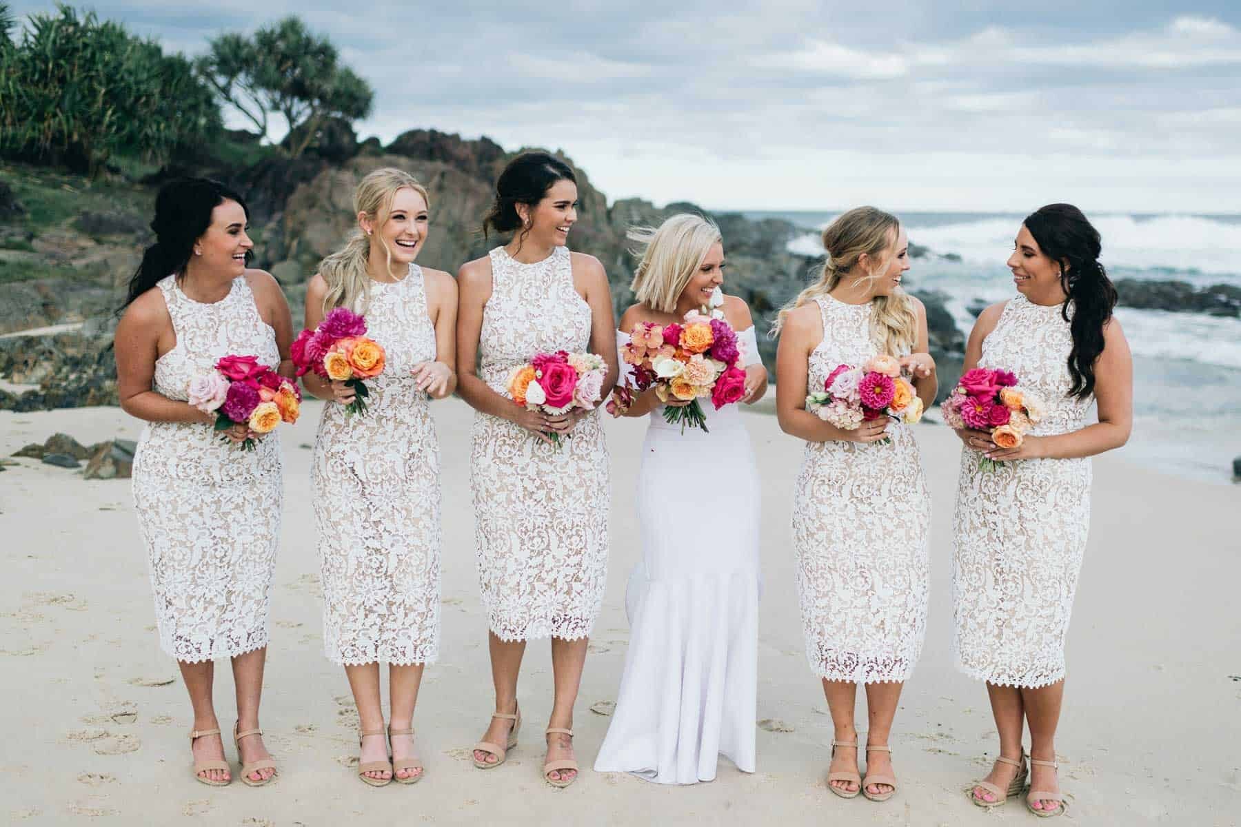 white lace bridesmaid dresses with pink bouquets