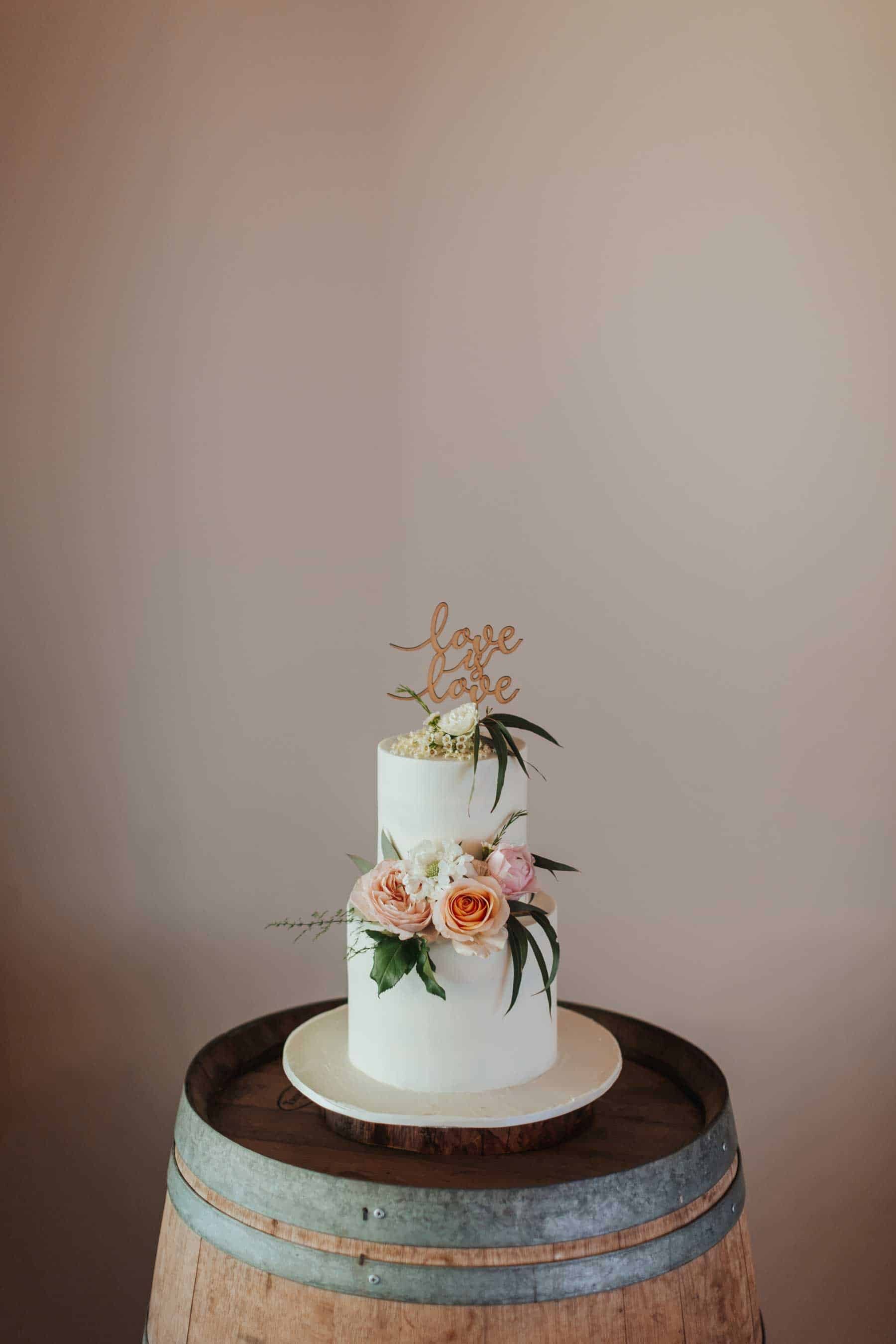 simple two tier wedding cake with peach flowers