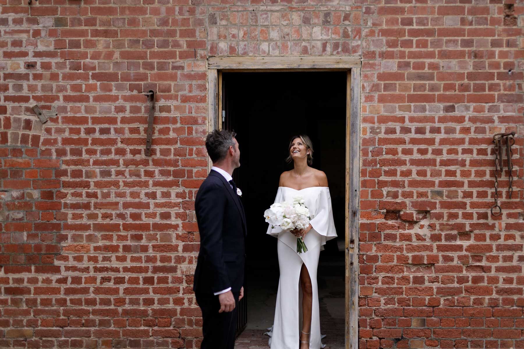 modern off-shoulder wedding dress with cape detail