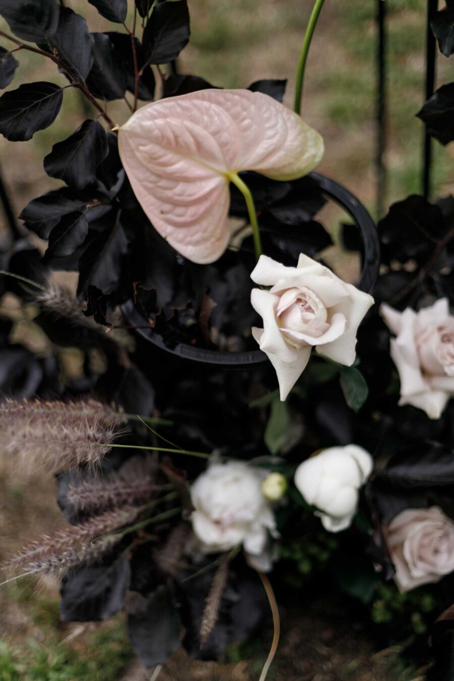 modern floral wedding backdrop with wire plinths