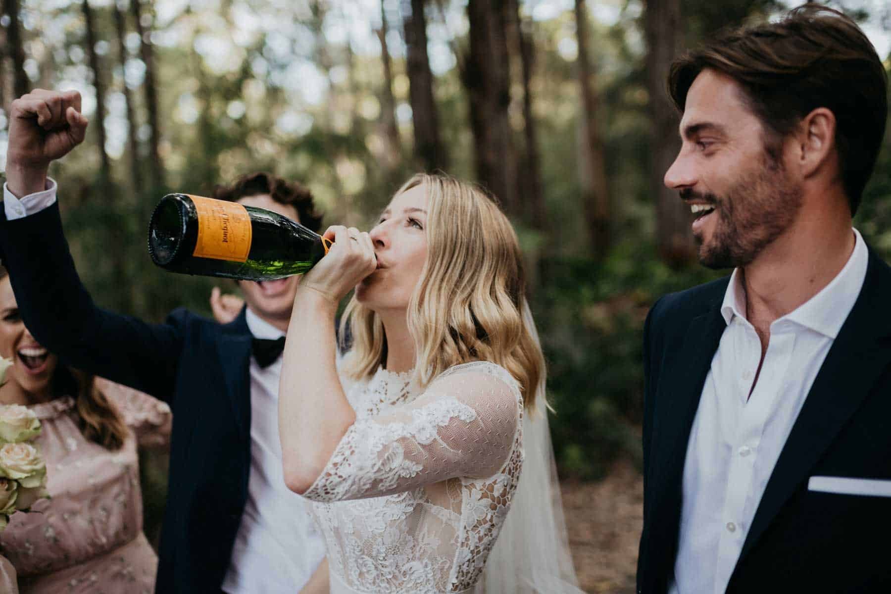 bride drinking champagne from the bottle