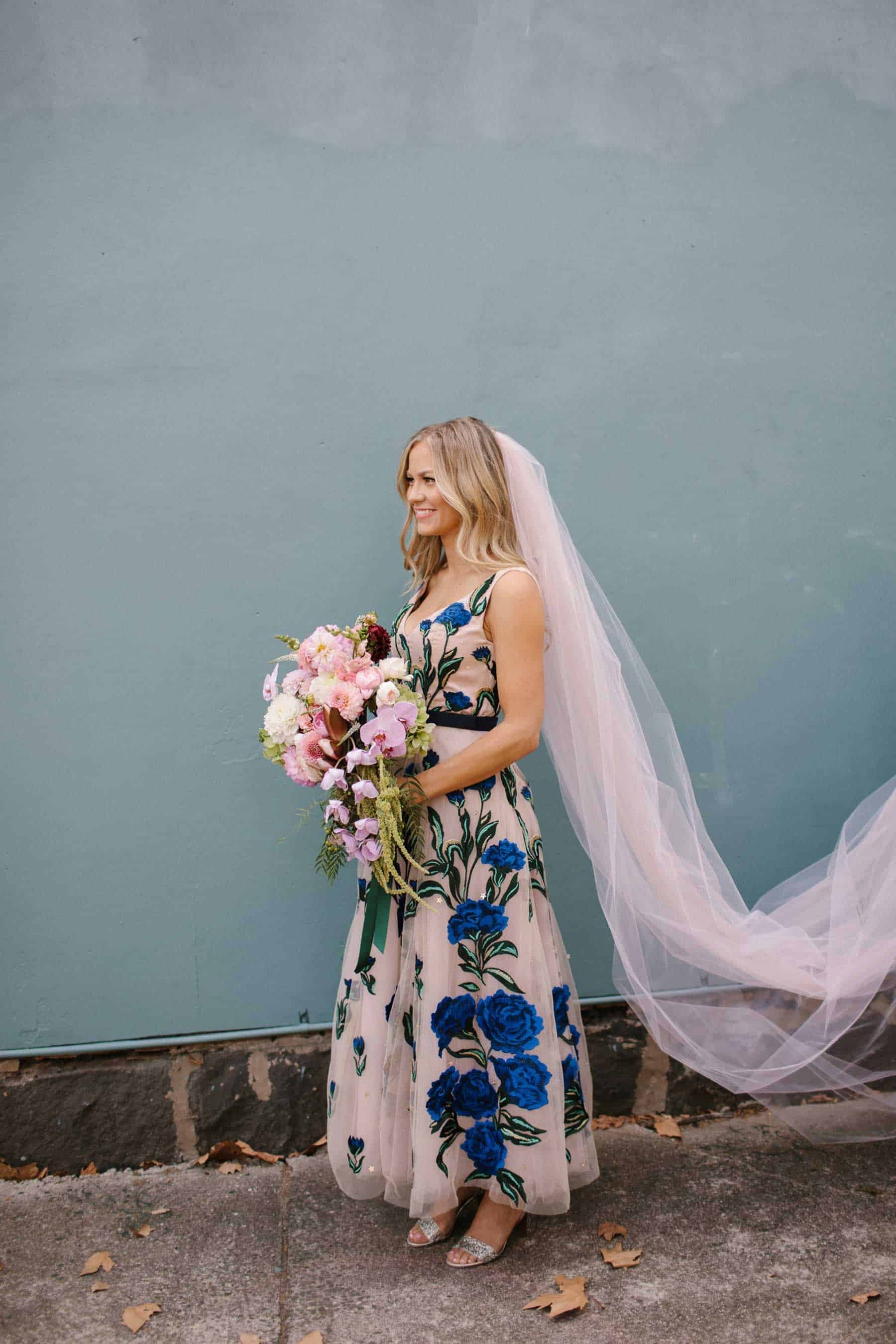 blush wedding dress with blue floral applique