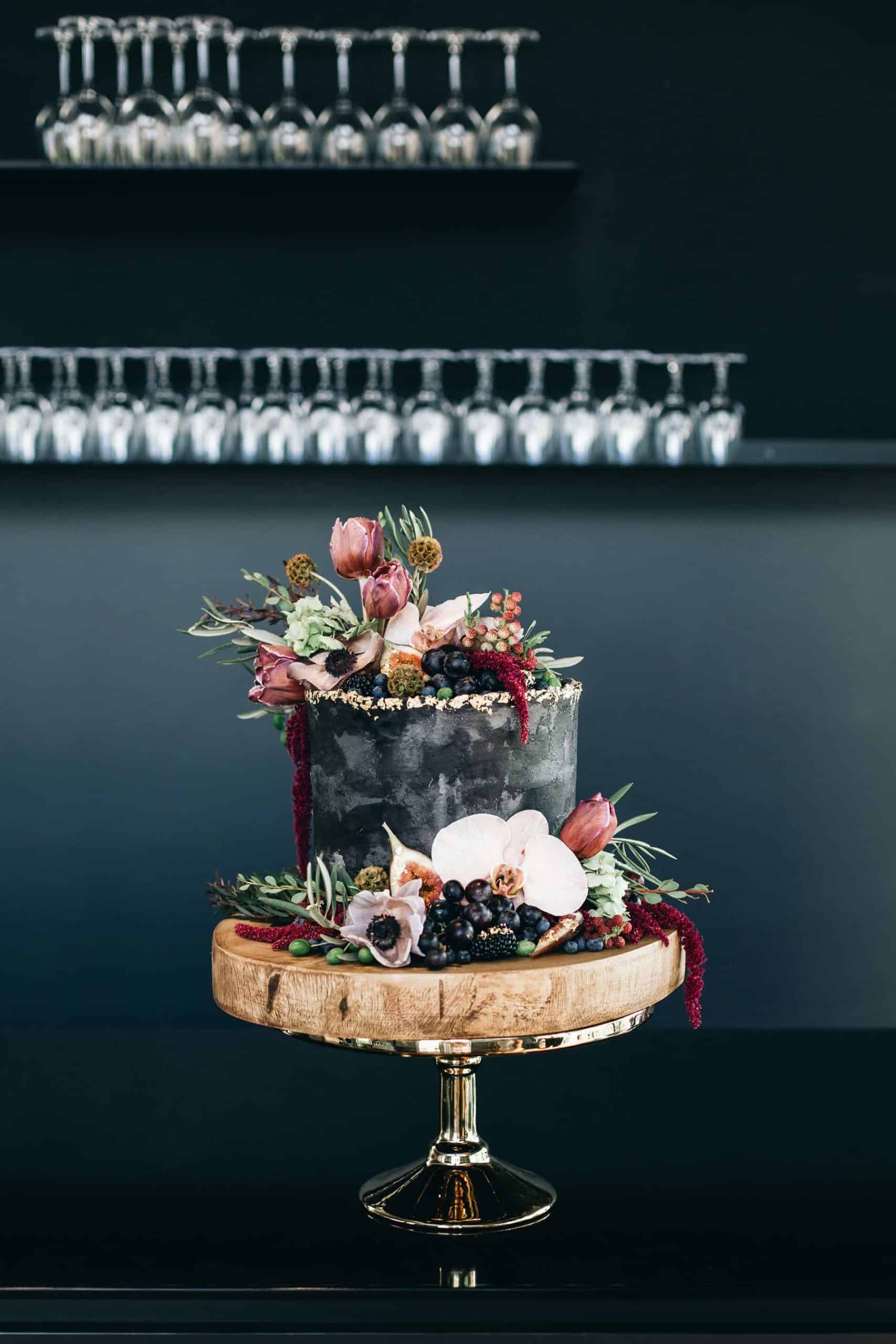 best wedding cakes of 2019 - black cake with fresh flowers
