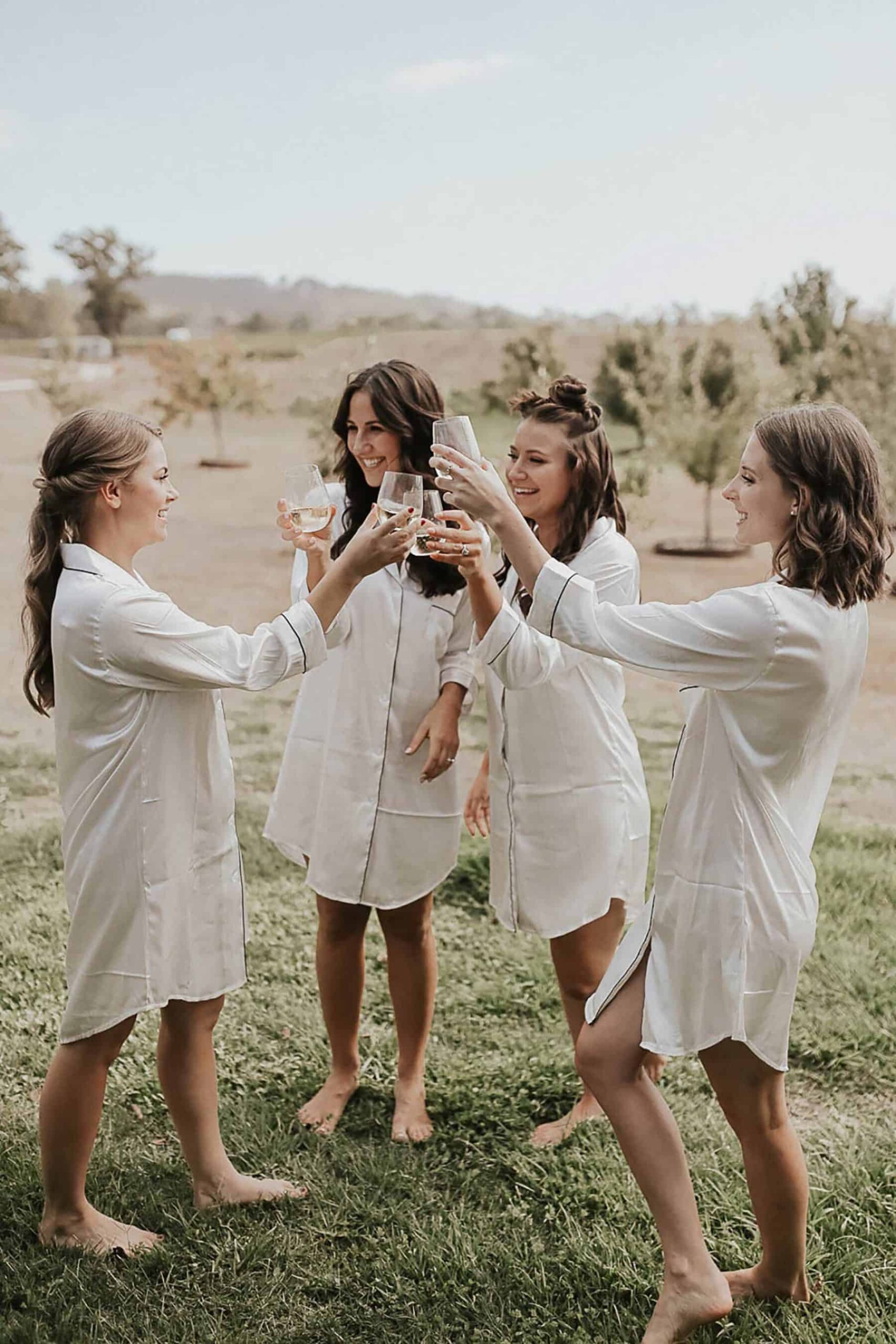 bridesmaids getting ready in silk shirts