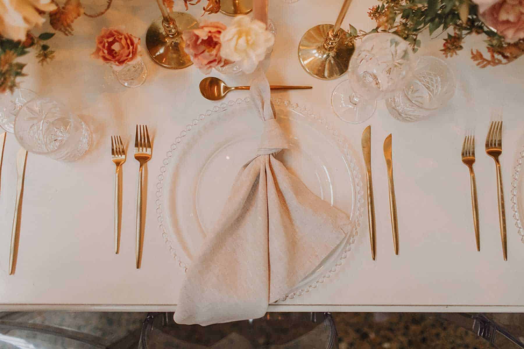 romantic table setting with gold cutlery