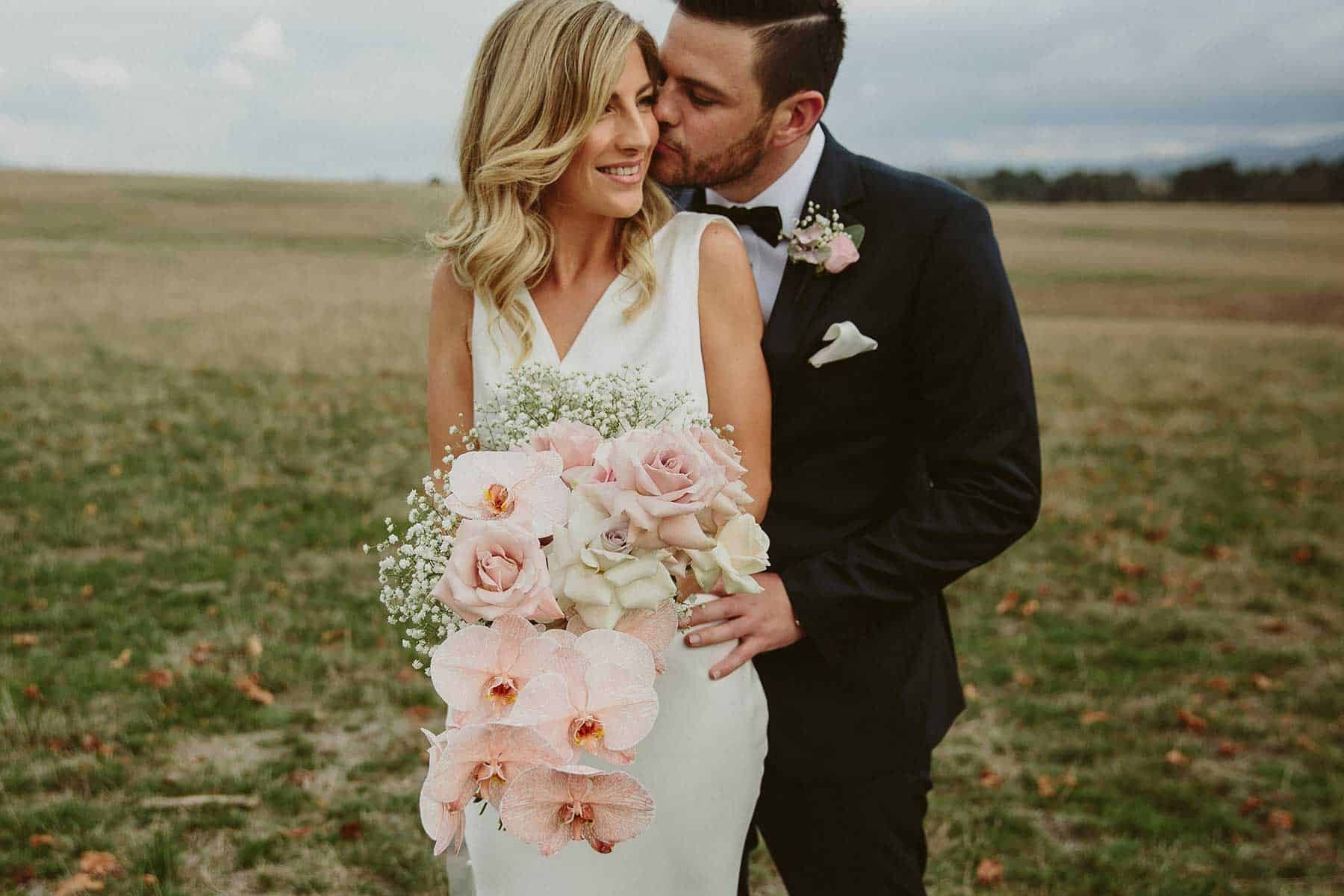 cascading blush bridal bouquet with orchids and quicksand roses
