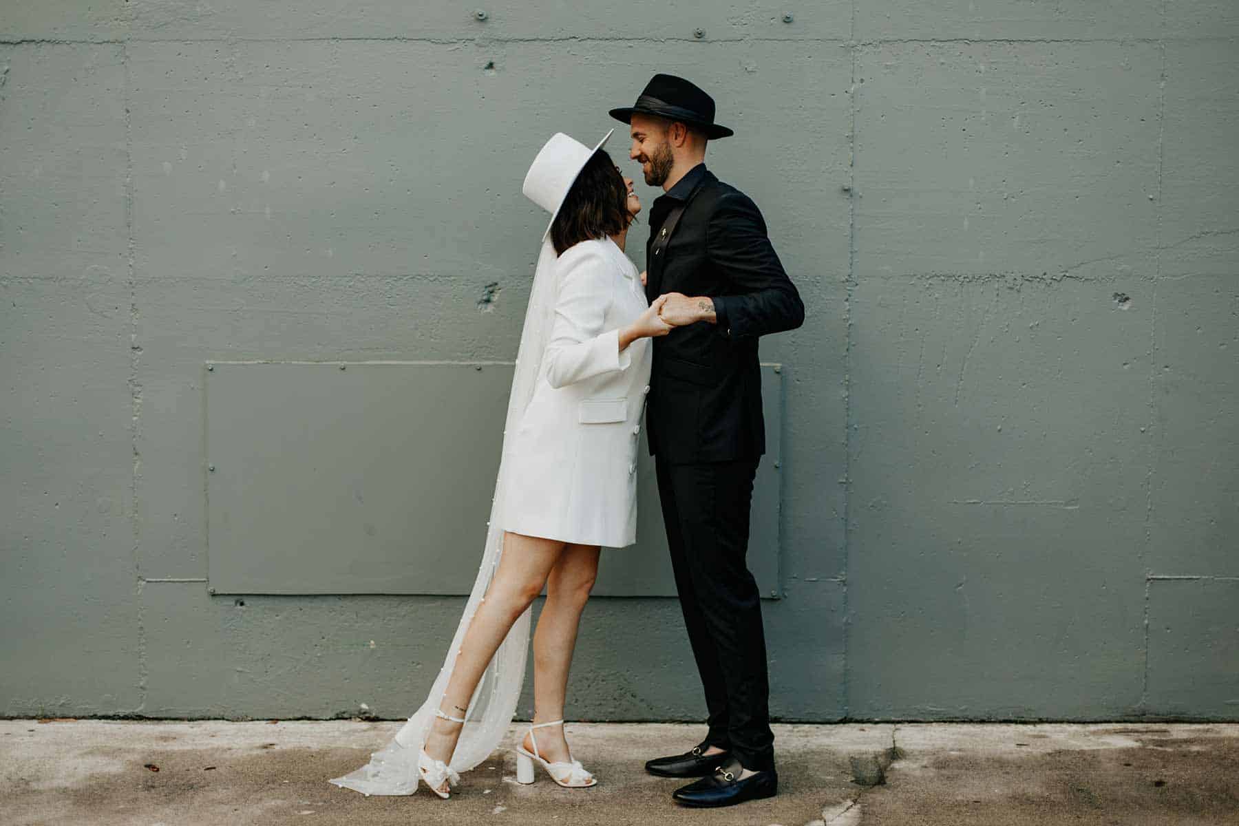 modern bride and groom in fedora hats