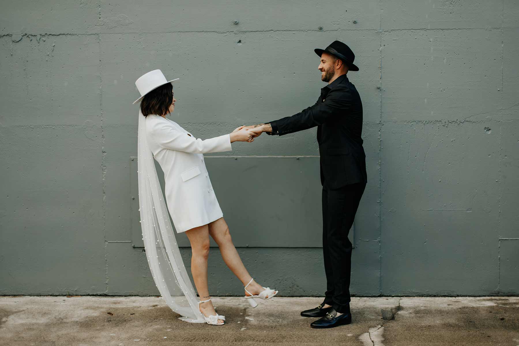 modern bride and groom in fedora hats