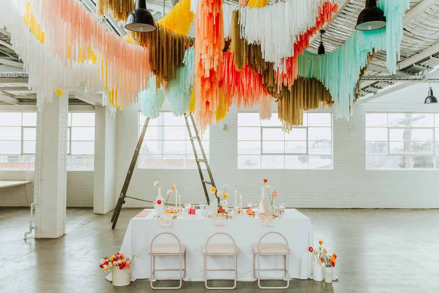 warehouse wedding with colourful hanging streamer installation