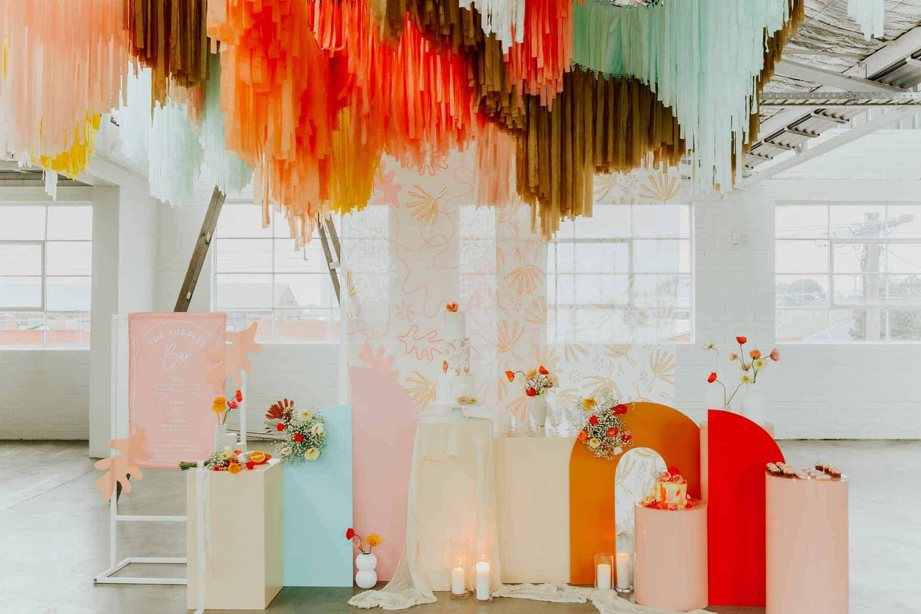 warehouse wedding with colourful hanging streamer installation
