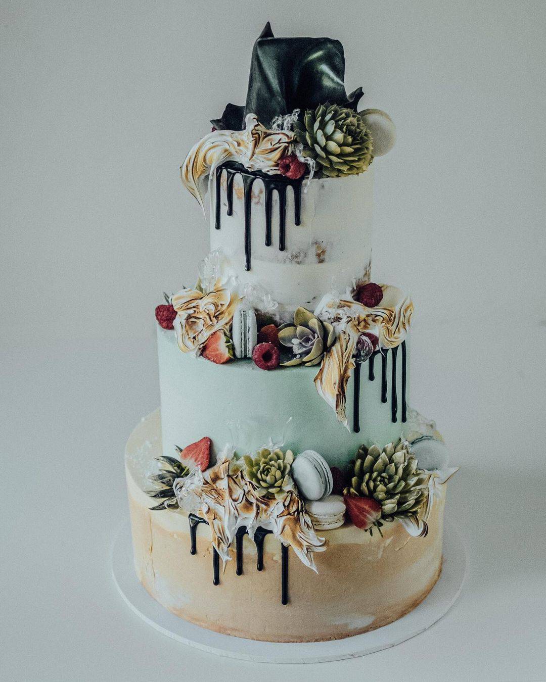 Fun modern wedding cake with macarons and chocolate drip