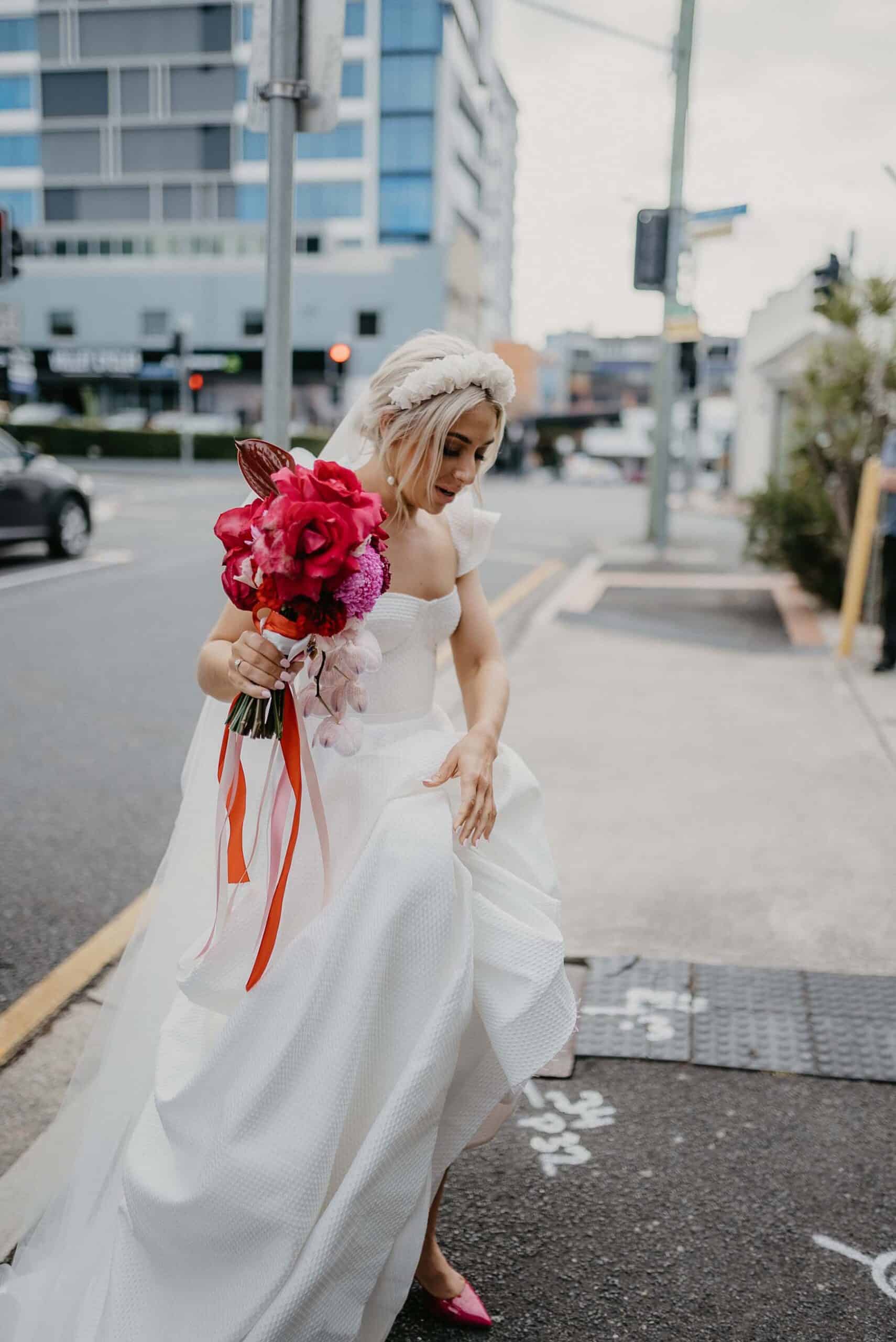 Boho bride with Red and pink wedding bouquet